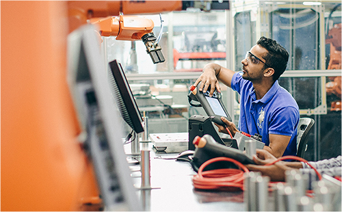 Engineer controlling robot arm